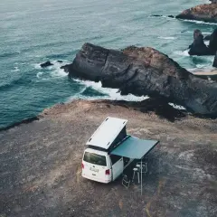 Van aménagé en bord de falaise, vue sur l'océan Atlantique. Un décor parfait pour le camping sauvage au Portugal.