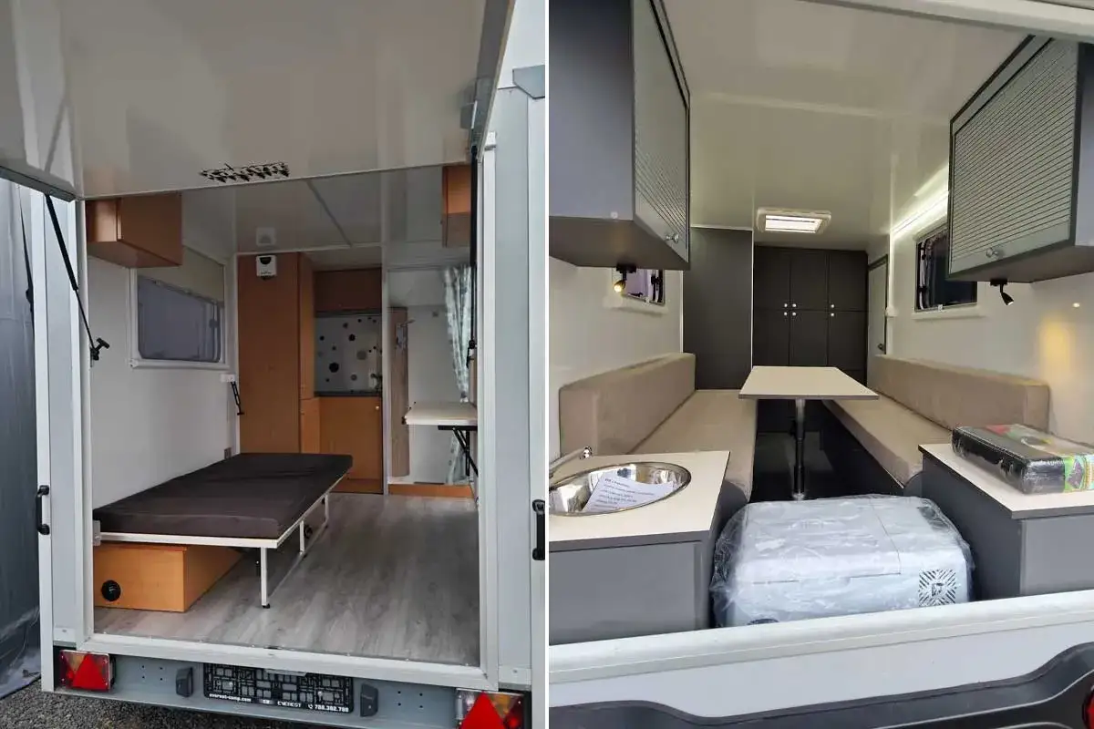 Int&eacute;rieur d'une caravane goutte d'eau avec lit, coin repas et cuisine.